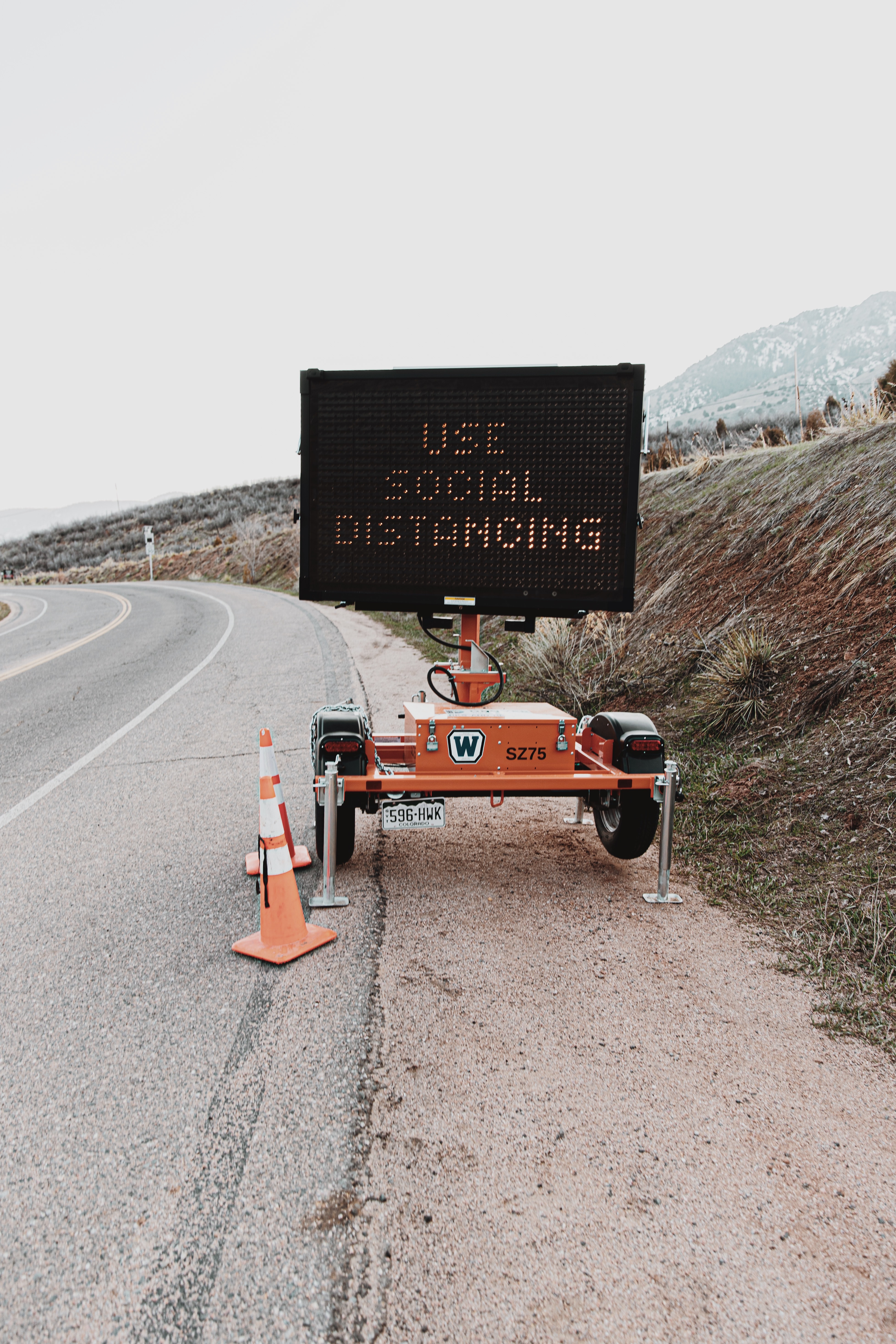 outdoor sign urges social distancing