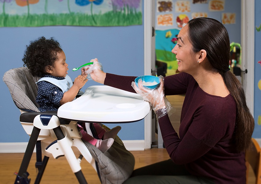 mother feeding baby healthy food